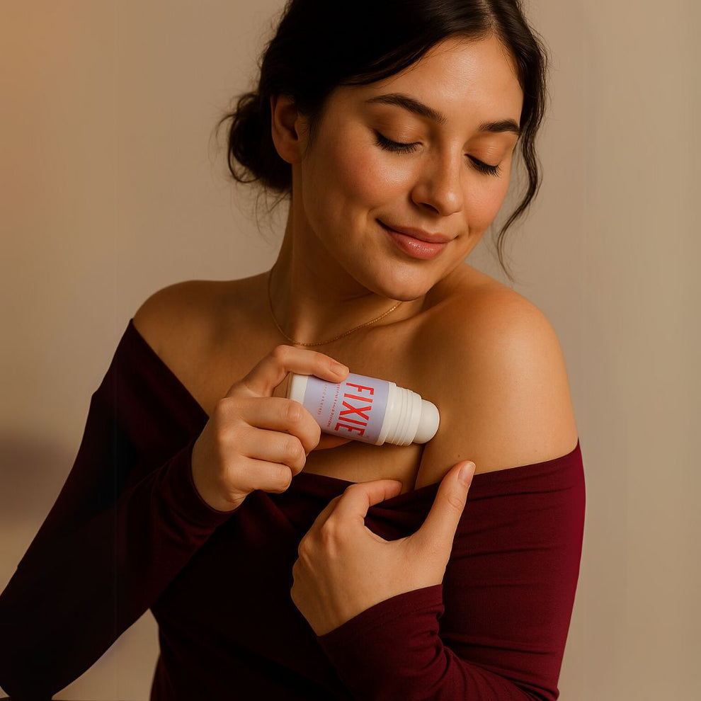 Woman applying a deodorant stick labeled 'FIXED' on her arm against a beige background